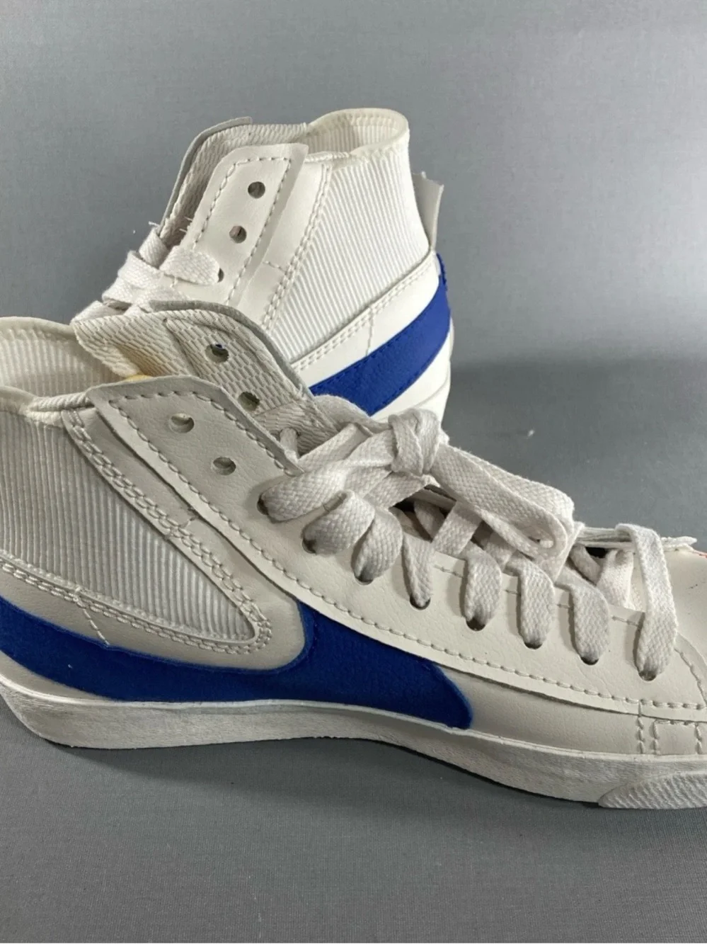 Nike Kids White High-Top Sneakers with Blue Swoosh and Red Stitching
